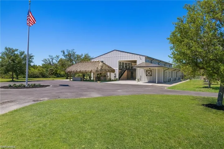 View of front facade featuring a front yard and a carport