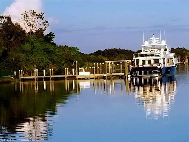 Property view of water featuring a boat dock