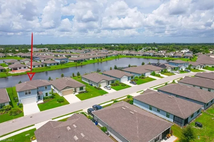 Birds eye view of property with a water view