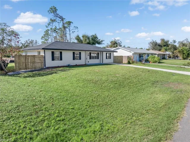 Ranch-style home featuring a front yard