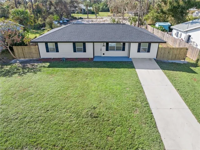 Ranch-style home featuring a front yard