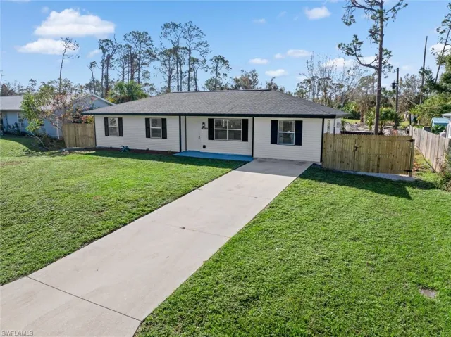 Single story home with a front lawn