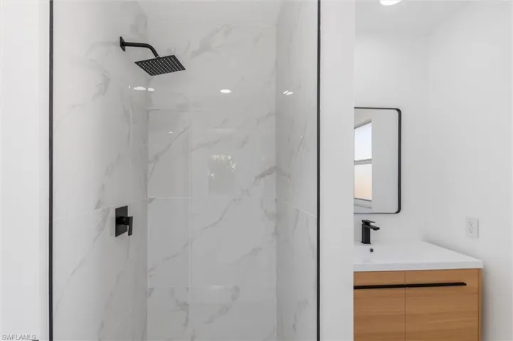 Bathroom with vanity and a tile shower