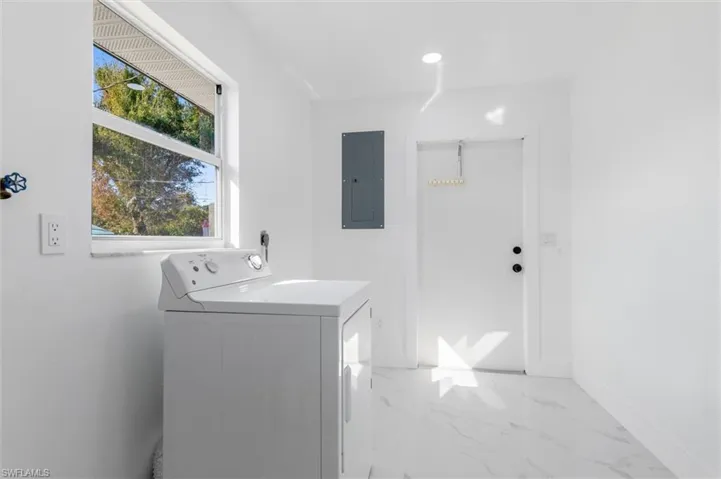 Clothes washing area with washer / clothes dryer and electric panel