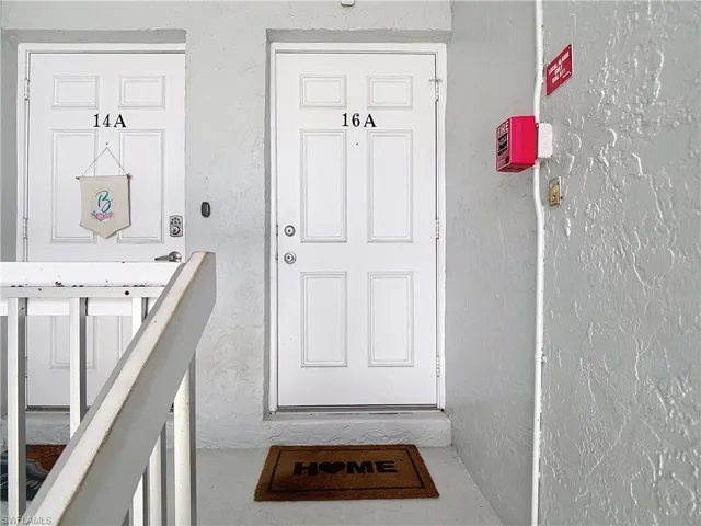 Doorway to property with stucco siding