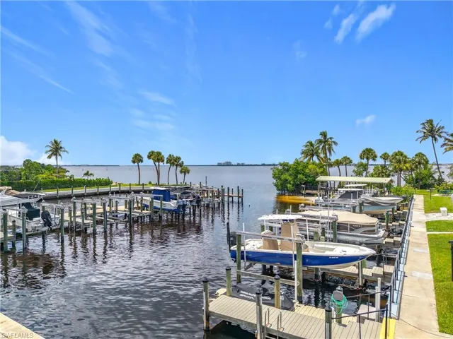 Dock area with boat lift and a water view