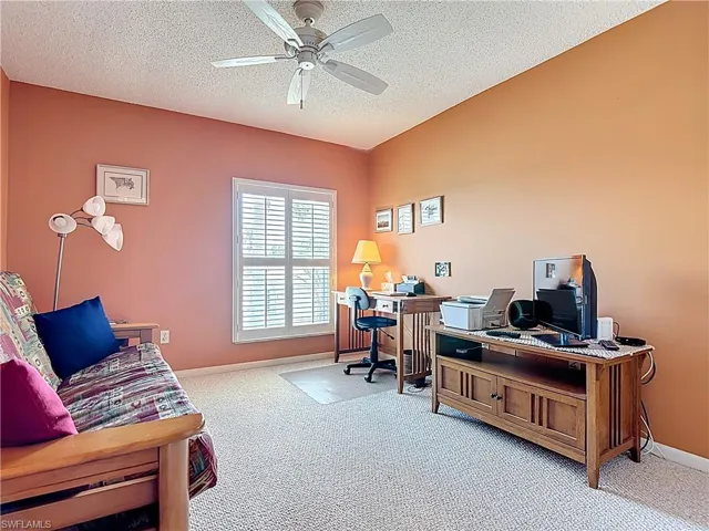 Home office with carpet floors, a textured ceiling, and ceiling fan