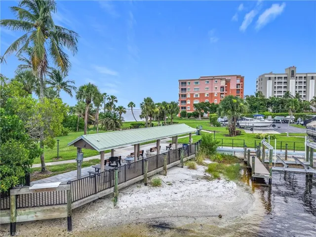 Surrounding community featuring a water view and a dock