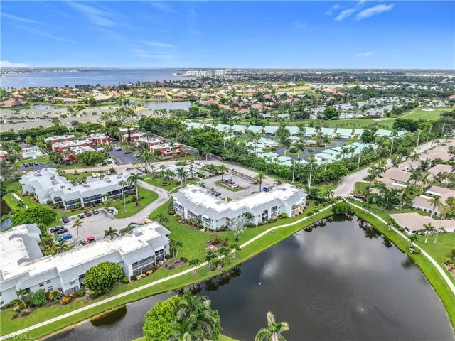 Aerial view of property and surrounding area featuring a large body of water