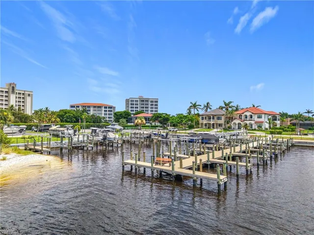 Dock featuring boat lift and a water view