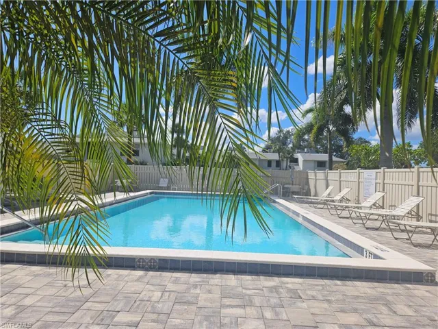 Community pool with a patio