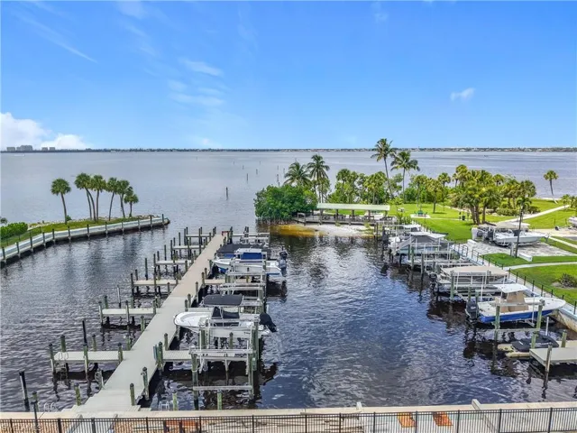 Dock area featuring boat lift and a water view