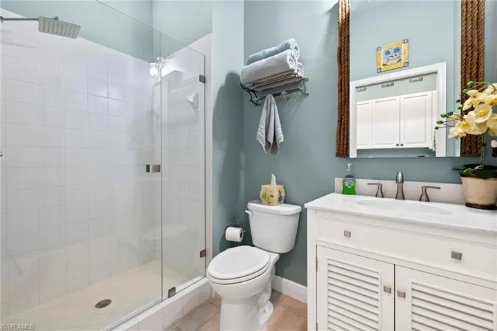 Guest bath with walk in shower, new vanity, toilet. Colorful but peaceful!