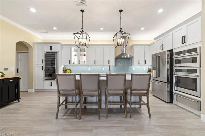 Lighting, fixtures, island, seating, and soft neutral colors; are all designed to be welcoming and pleasing.