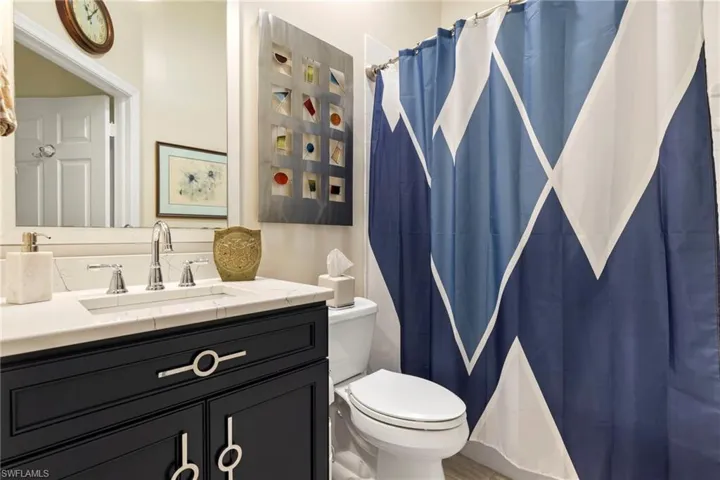 Custom guest bathroom with new vanity, fixtures, toilet and bath.