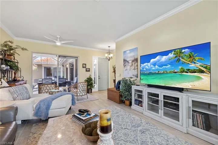 Great room featuring crown molding, ceramic tile flooring, looking onto Courtyard.