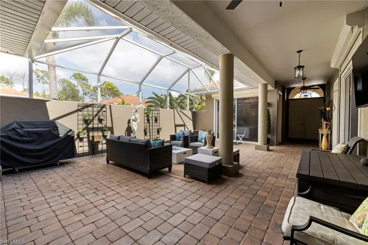 View from Main House front door to Courtyard door, Pavers, lighting and fan fixtures. Plenty of room for entertaining and relaxation.