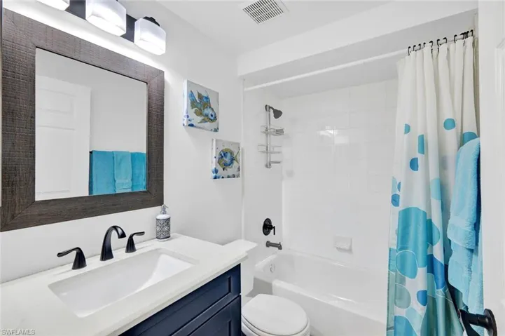 Guest Bathroom featuring vanity and shower / bath combo with shower curtain