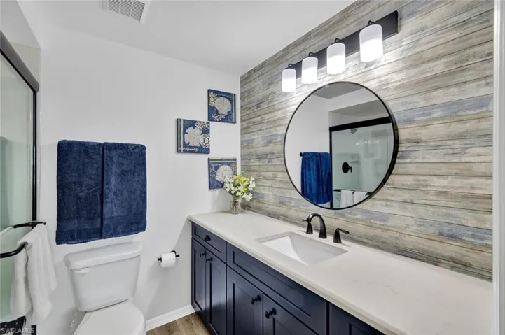 Full bathroom featuring vanity and a shower with shower door