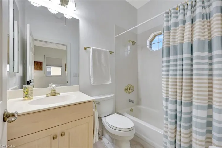 Full bath featuring vanity and shower / tub combo with curtain