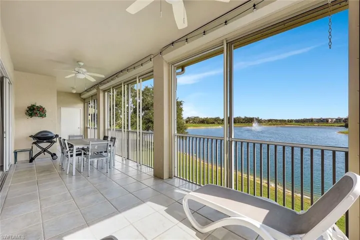Sunroom featuring a water view and tile patterned floors