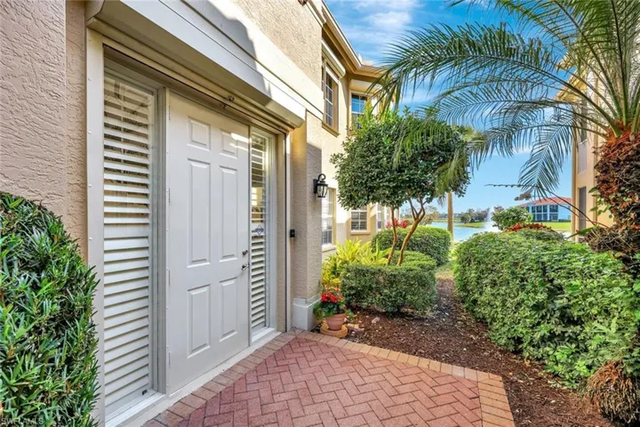 Entrance to property featuring a water view and stucco siding