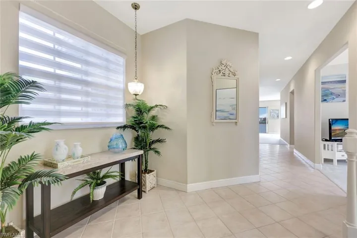 Corridor featuring light tile patterned floors and recessed lighting