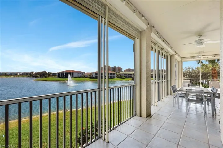 Sunroom / solarium featuring a water view and tile patterned floors