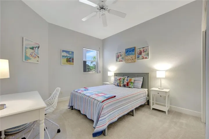 Carpeted bedroom with baseboards and ceiling fan