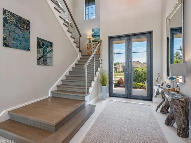 Tiled entrance foyer with a wealth of natural light and a towering ceiling