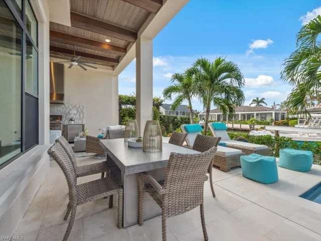 View of patio / terrace featuring a grill, ceiling fan, and exterior kitchen