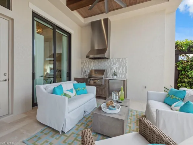 View of patio featuring a grill, ceiling fan, outdoor lounge area, and exterior kitchen