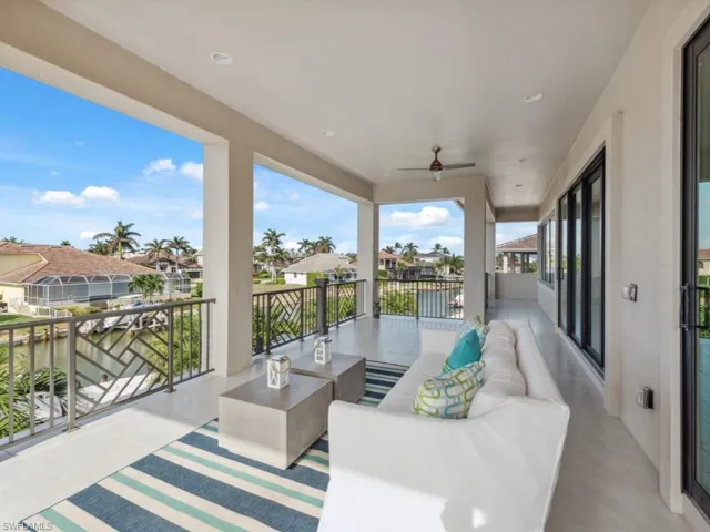 View of patio / terrace with outdoor lounge area, a water view, ceiling fan, and a balcony