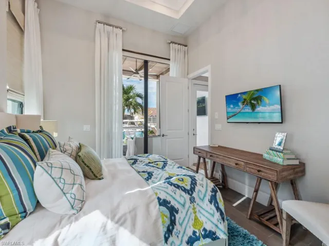 Bedroom with dark hardwood / wood-style floors and access to outside