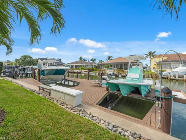View of dock with a water view and a yard