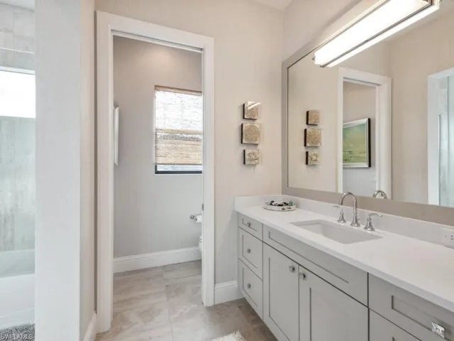 Full bathroom with  shower combination, vanity, toilet, and a healthy amount of sunlight