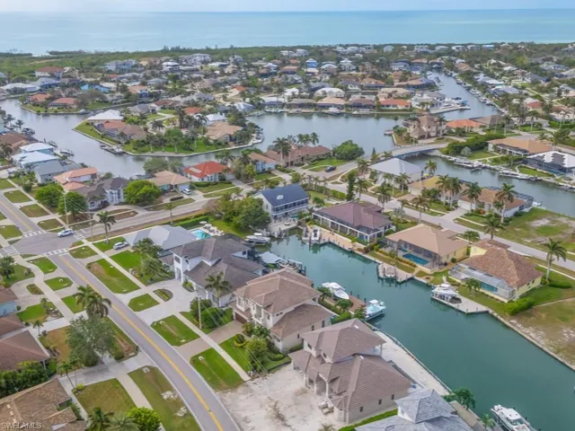 Birds eye view of property with a water view