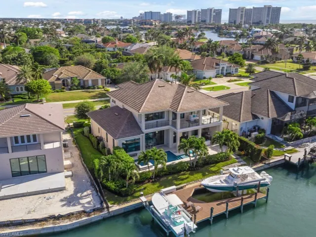 Birds eye view of property with a water view