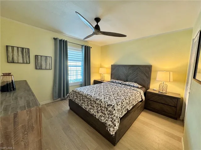 Guest Bedroom featuring light wood-style floors and a ceiling fan