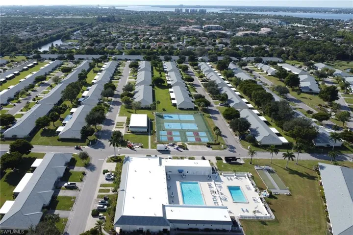 Aerial overview of property's location featuring a large body of water and a pool area