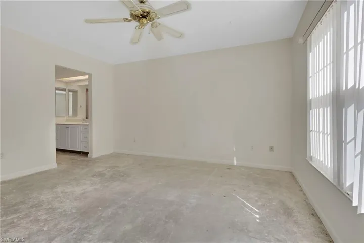 Unfurnished room with baseboards and ceiling fan