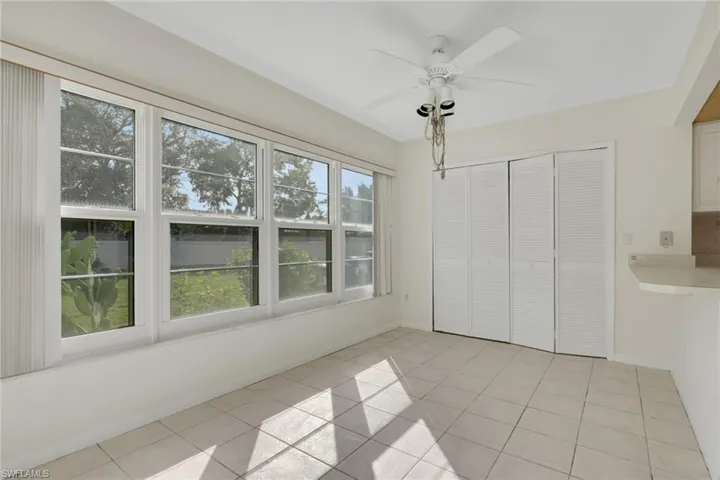 Unfurnished bedroom with light tile patterned floors, a ceiling fan, and a closet