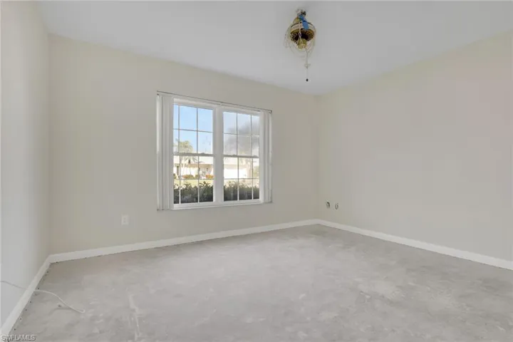 Empty room with baseboards and unfinished concrete flooring