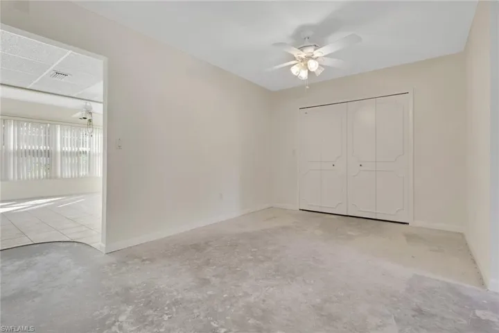 Unfurnished bedroom with a closet and a ceiling fan