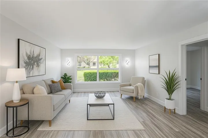 Living area with wood finished floors and baseboards