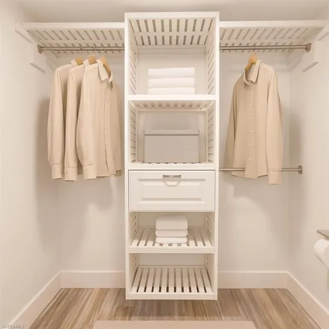 Spacious closet with wood finished floors