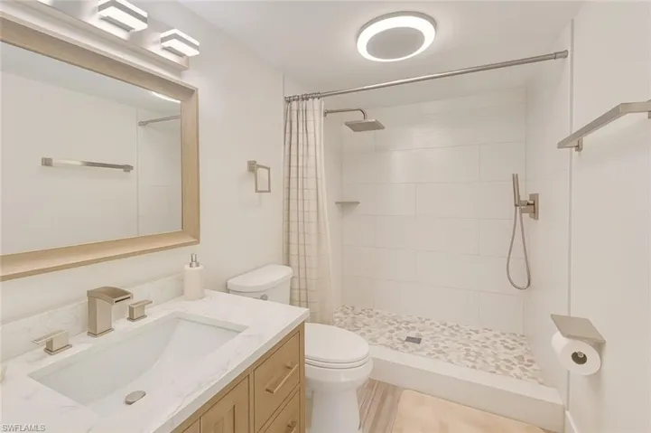 Full bathroom with vanity and a tile shower