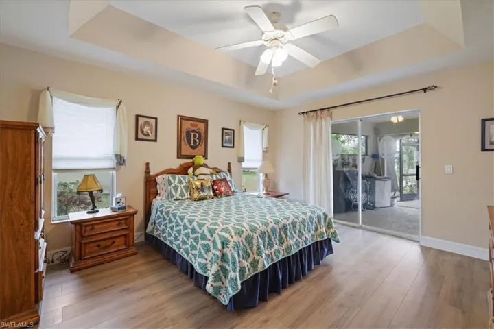 Primary Bedroom with water views and sliders to the covered lanai