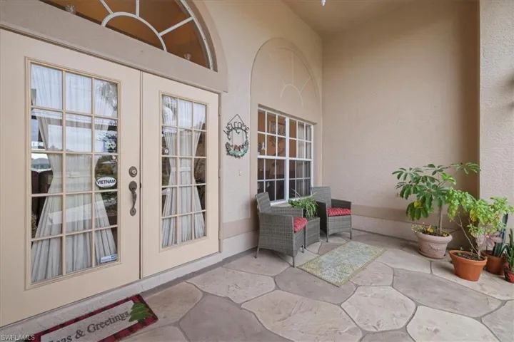 Front entrance featuring french doors, and a spacious screened patio