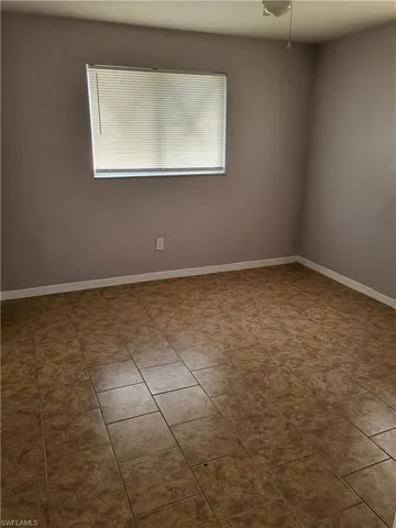 Spare room with light tile patterned flooring